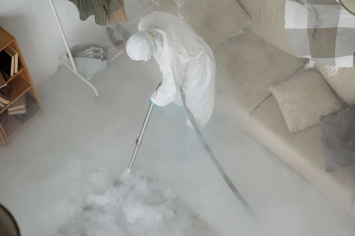 Biohazard cleanup technician in protective equipment, Davidson, Kansas City, MO